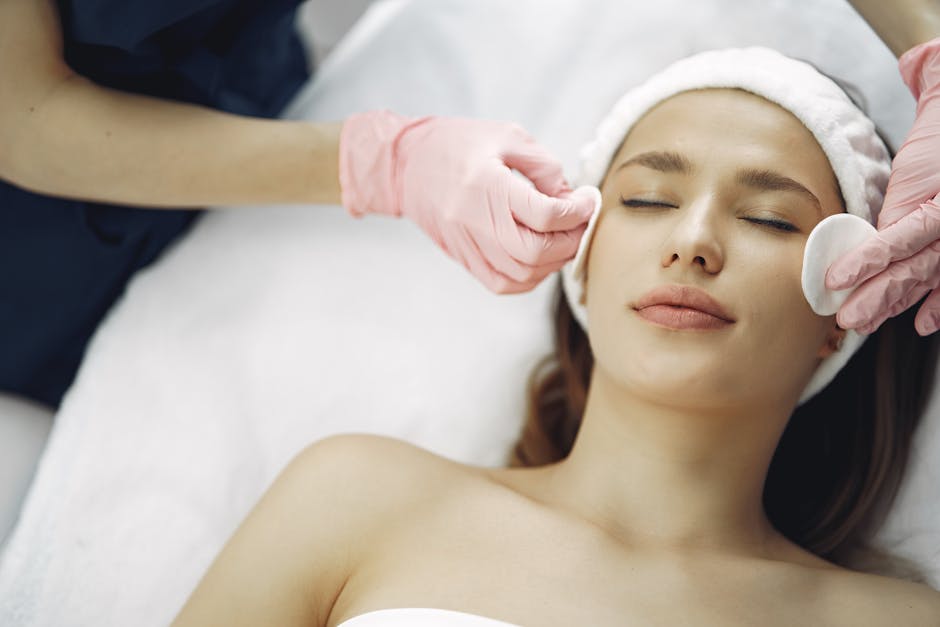 Woman enjoying a soothing facial treatment in a serene spa setting, promoting relaxation and beauty.